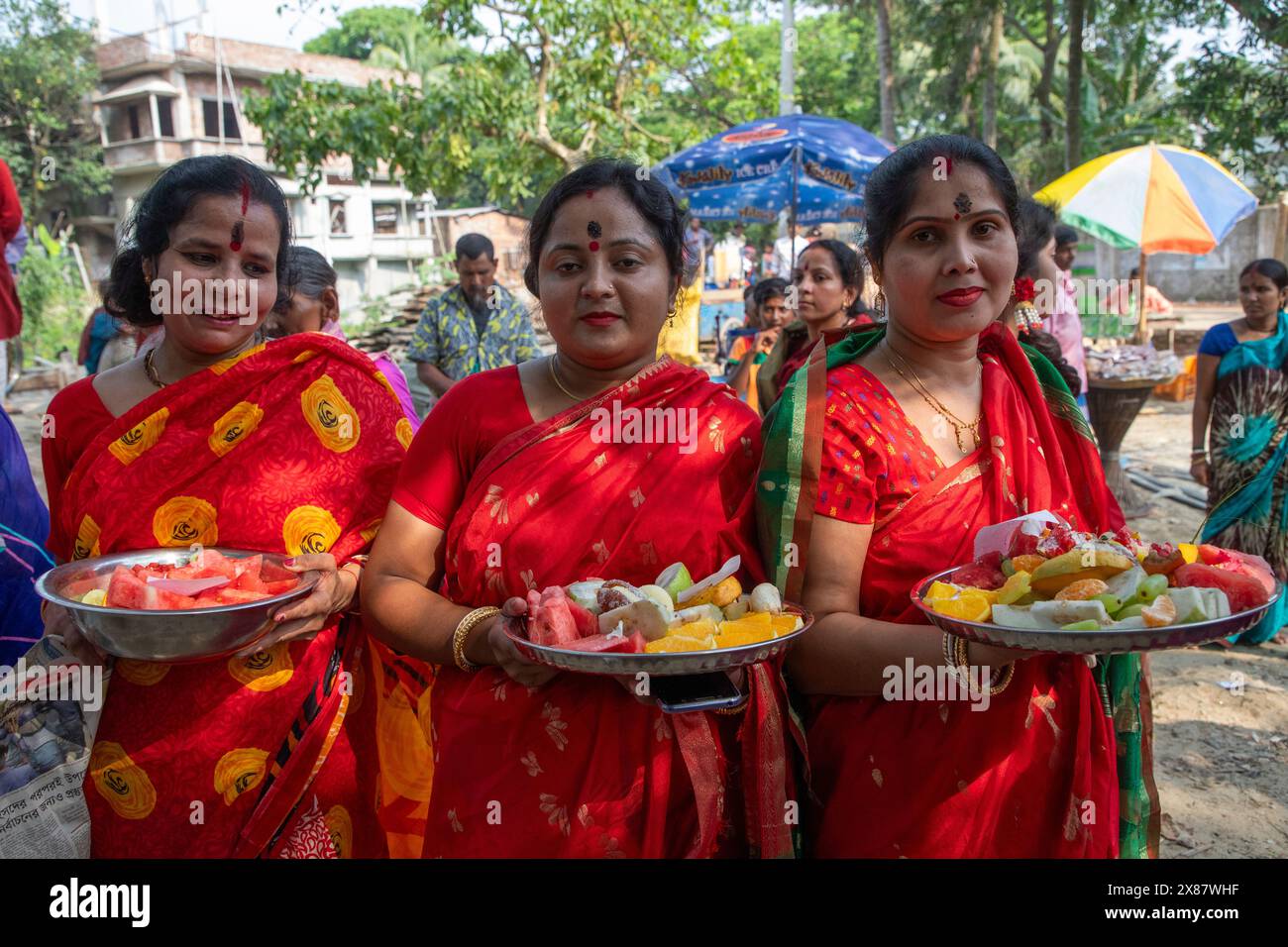 Women take offering to `Boumela’ at Sonargaon Upazila Parishad in Narayanganj. Following an ancient tradition upheld by the local Hindu community. Thi Stock Photo